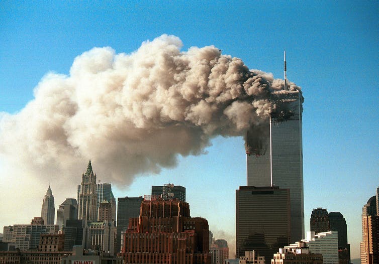 Smoke pours from the Twin Towers of the World Trade Center in New York City on September 11, 2001.