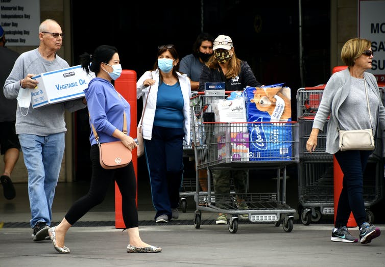 shoppers mostly all wearing masks