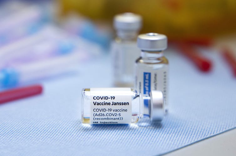 Close-up of three Johnson & Johnson vaccine vials.