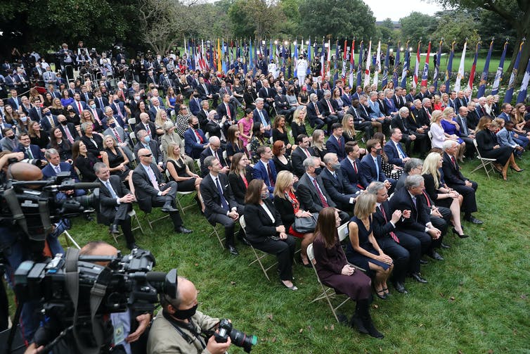 The crowd seated side-by-side in the Rose Garden.