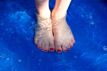 Girl with feet in pool