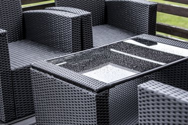 Wet plastic rattan and glass garden furniture