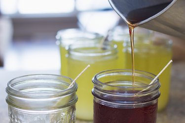 Pouring hot soy wax into glass jars