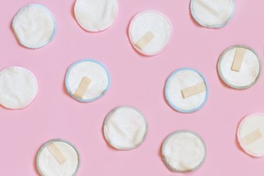 Reusable makeup remover pads on pink background