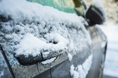 Car door handle covered in frost