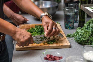 preparing and cutting kale to make a salad