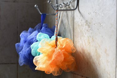 colorful loofahs hanging in shower