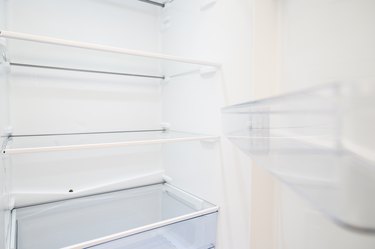 Empty refrigerator with open door