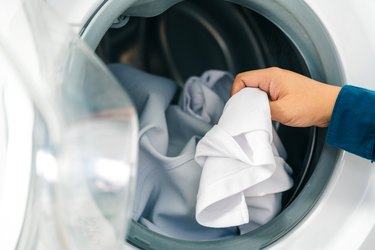 Putting clothes in dryer