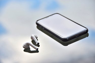 Close-Up Of Headphones With Smart Phone On Table