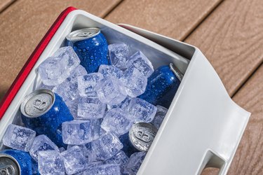 Cooler full of ice cold drinks cans