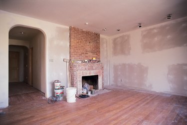 Unfinished living room with fireplace