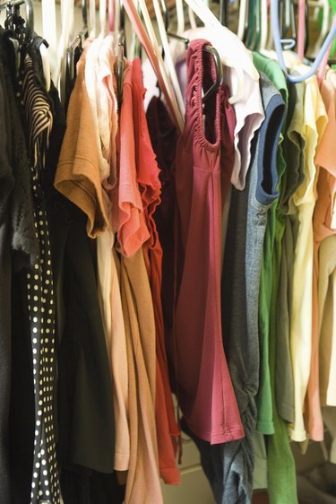 Clothes hanging in woman's closet