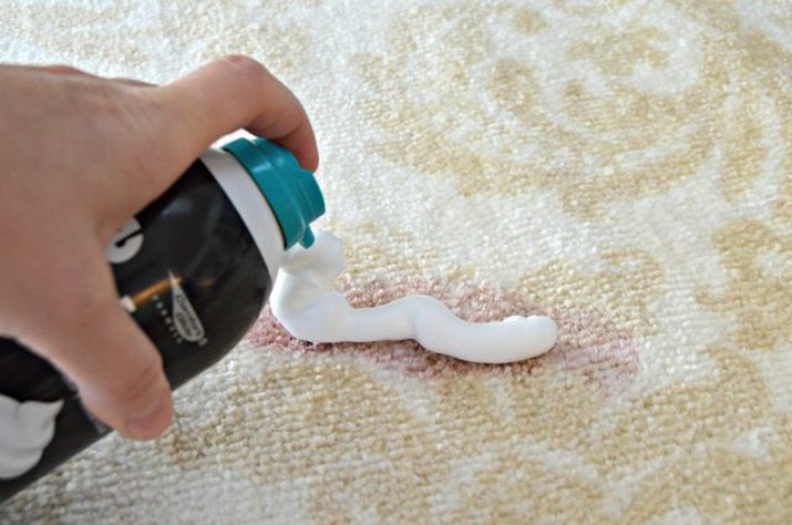 Shaving cream applied to red wine stain on white carpet