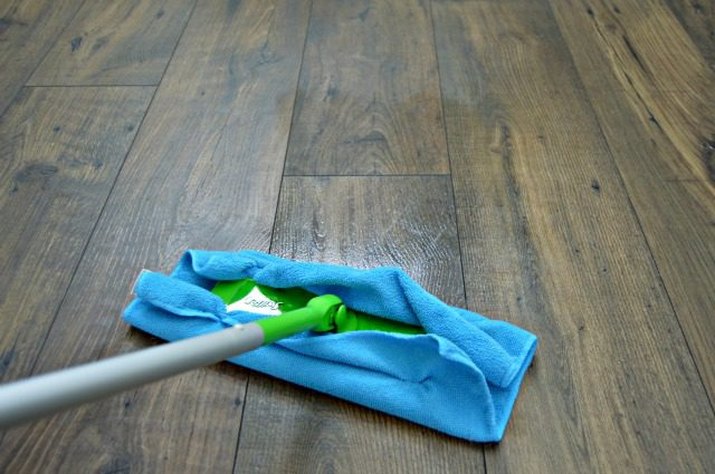 Microfiber towel attached to a Swiffer cleaning wood flooring