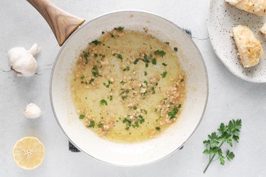 Add lemon juice, broth and parsley