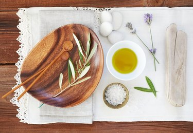 Organic oil and salt with lavender on table cloth