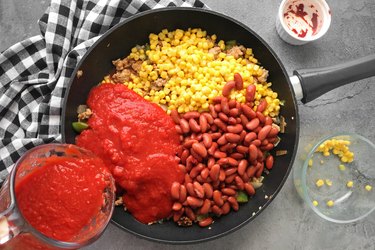Add crushed tomatoes and simmer