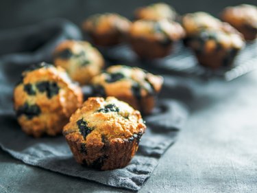 Homemade blueberry muffins on dark background.