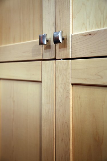 Contemporary wooden cabinets with metal knobs
