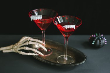 Bloody vampire cocktails with fangs as garnish