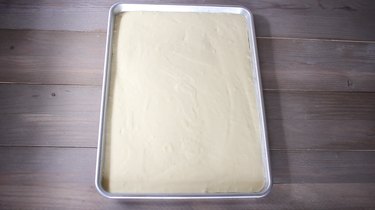 Cake batter poured into large sheet pan
