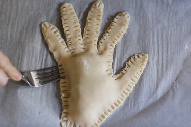 Crimping edges of hand pie with fork