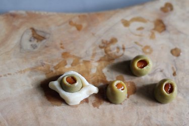 Green olives cut in half and wrapped with dough