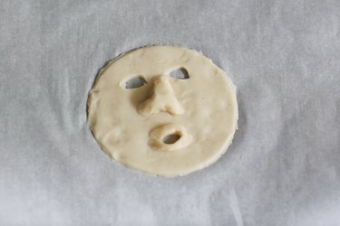 Shrunken head features shaped into dough