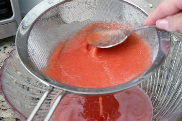 press the pulp against the strainer