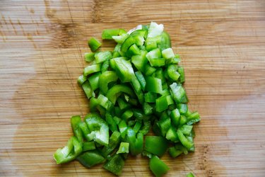 Green bell pepper on a cutting board