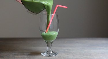 Pouring smoothie into glass