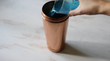 Pouring blue curacao into shaker