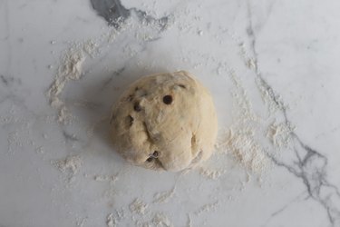 Set the dough onto a lightly floured surface and knead to bring it together.