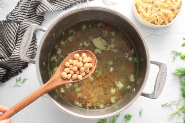 Add broth, chickpeas and bay leaf