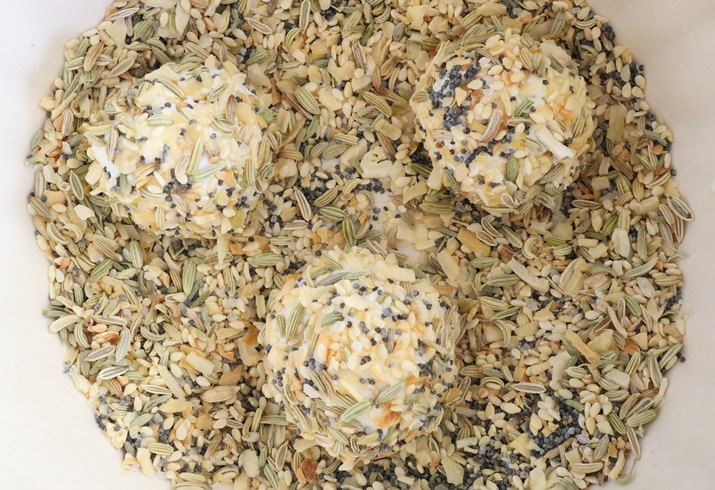 Coat goat cheese balls with spices
