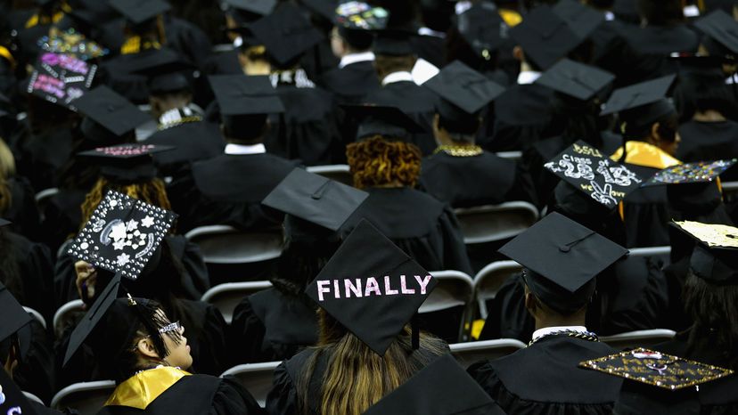 Graduates of Bowie State University put messages on their mortarboard hats
