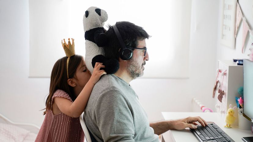 little girl with dad working from home