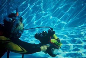 Gene helps Hawkeye perform a trick called &quot;float in pool.&quot;