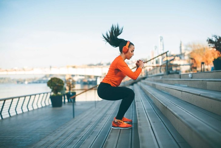 Fitness woman jumping outdoor in urban environment