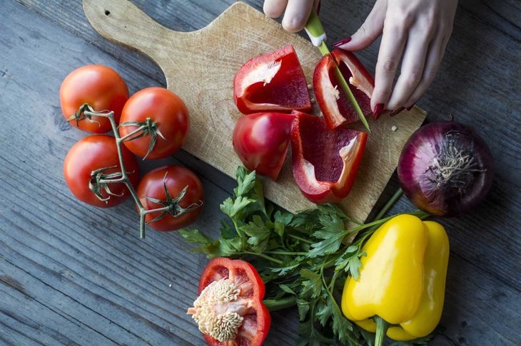 Woman's hand preparing salad