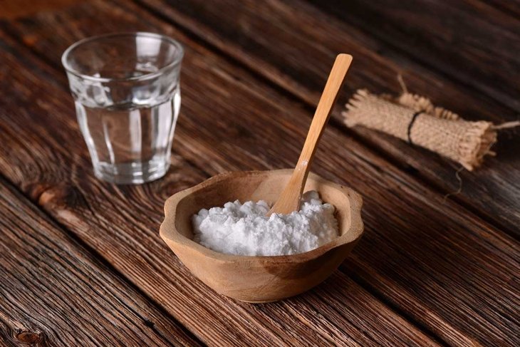 baking soda into the bowl with wooden spoon