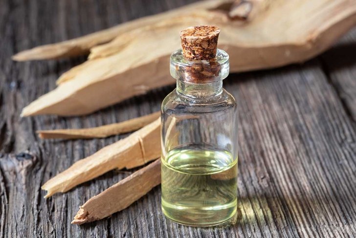 A bottle of essential oil with white sandalwood