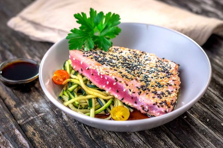 Grilled tuna steak with vegetable pn wooden background